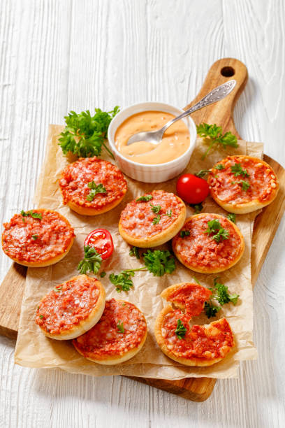istock mini pizzas with ham and pecorino cheese, top view 1414377399