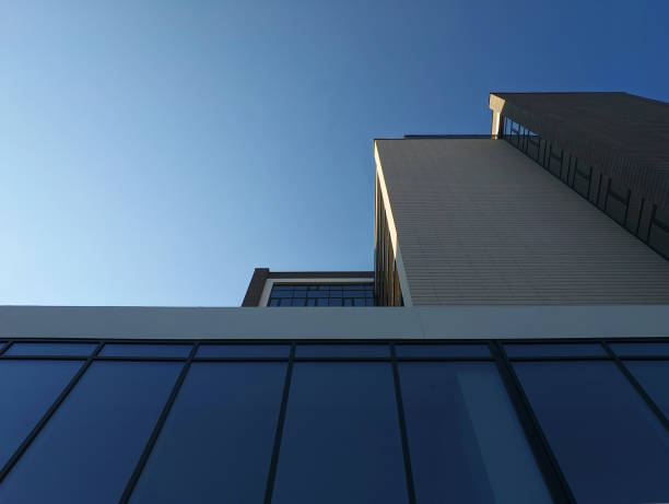 istock Modern building with glass, concrete and brick facade against the blue sky 1414377472