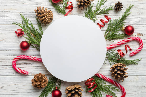 istock Flat lay Christmas composition. Round Paper blank, pine tree branches, christmas decorations on Colored background. Top view, copy space for text 1414378262