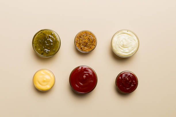 different types of sauces in bowls on a colored board . top view. various sauces copy space - tartar sauce imagens e fotografias de stock