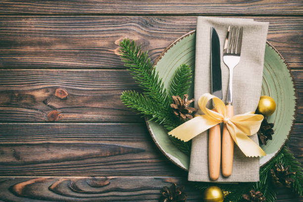 istock Christmas table place setting with christmas decor and plates, kine, fork and spoon. Christmas holiday background. Top view with copy space 1414378479