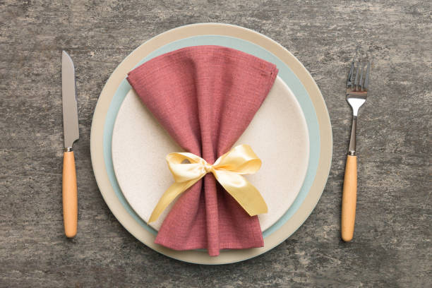 istock Christmas table place setting with christmas decor and plates, kine, fork and spoon. Christmas holiday background. Top view with copy space 1414378500