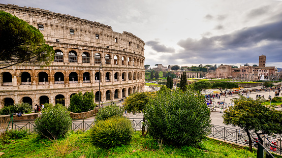 A suggestive cityscape of the Coliseum and the Imperial Forum in the core of Ancient Rome. The majestic Flavian Amphitheater, known as the Coliseum due to a colossal statue that stood nearby, was built in the 1st century AD. at the behest of the emperors of the Flavian dynasty, and hosted, until the end of the ancient age, shows of great popular appeal, such as hunting with exotic animals and gladiator games. According to data collected from the reservations of visitors and tourists by Trip Advisor, this Coliseum was one of the most visited monument in the world. In 1980 the historic center of Rome was declared a World Heritage Site by Unesco. Super wide angle image in 16:9 and High Dynamic Range format (HDR).