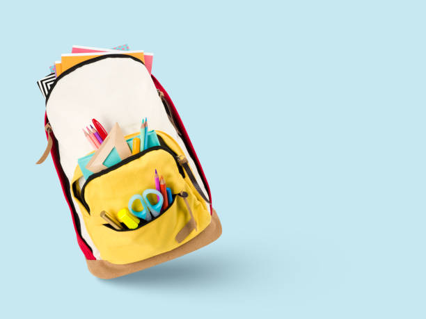istock Multicolor school backpack with different colorful stationery on blue background 1414378939
