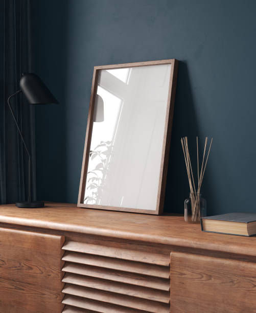 Mock-up frame in dark blue home interior with chest of drawers and decor stock photo