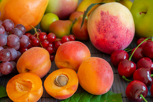 Summer fruits - apricot, peach, grapes, pear, cherries, currants