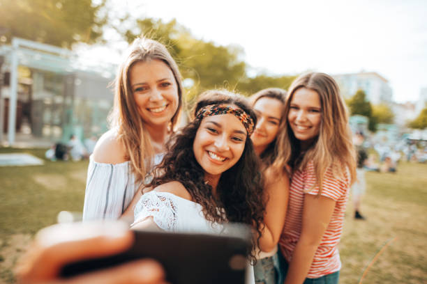 istock friends take a selfie in the park 1414381524