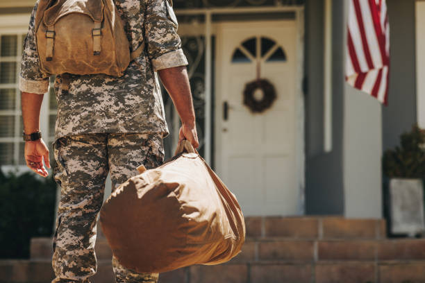 istock Unrecognizable soldier returning home from the army 1414383961