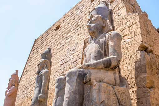 Statues of pharaohs holding ankh crosses in both hands