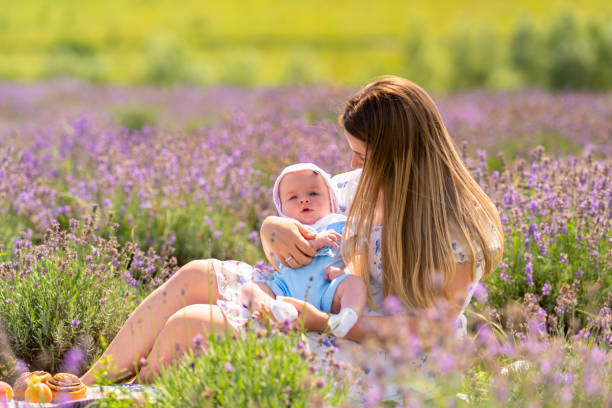 istock Young baby boy sleeping in its mothers arms 1414388697