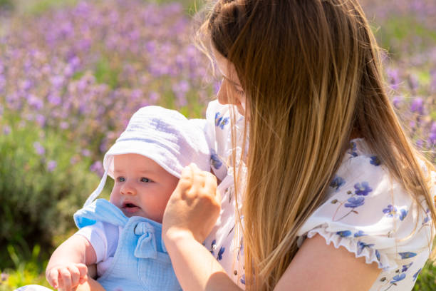 istock Caring young mother adjusting the sunhat on her baby 1414388935