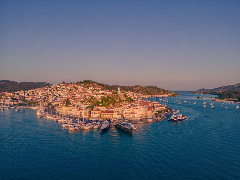 aerial panoramic photo of the island of Poros and the port of Galatas in Argosaronikos, Peloponnese, Greece at sunset