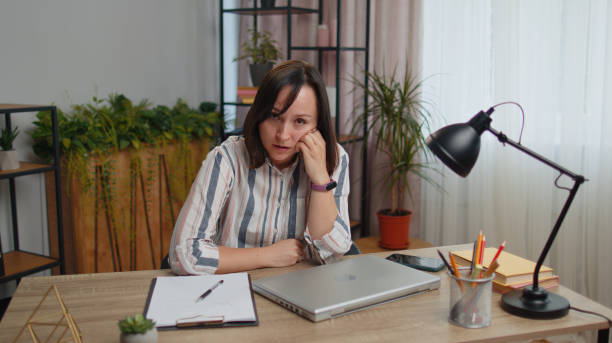 istock Young businesswoman analyzing documents, contract invoices or graphics report and working on laptop 1414392038