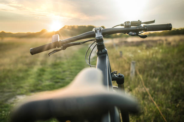 E-bike on the country road at sunset stock photo