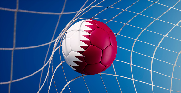Soccer ball with flag of Qatar hitting the net of goal