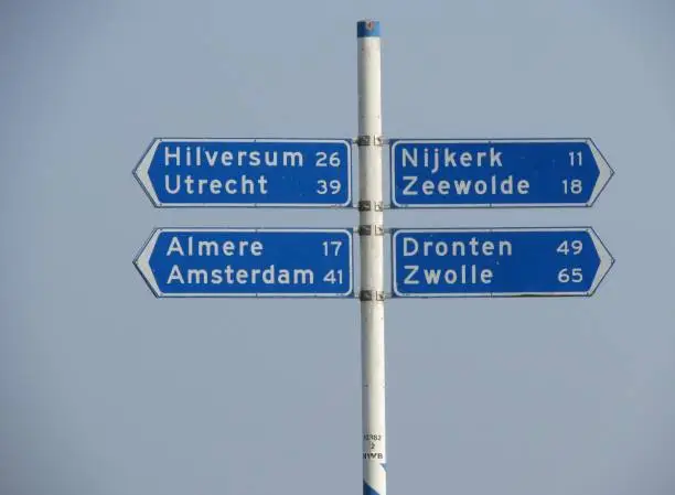 Blue roadsigns in the Netherlands, pointing towards cities including Amsterdam.