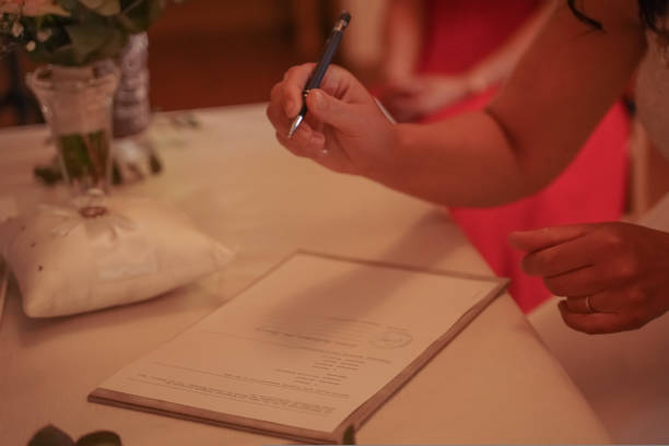 istock The bride's hands sign the wedding contract 1414397450