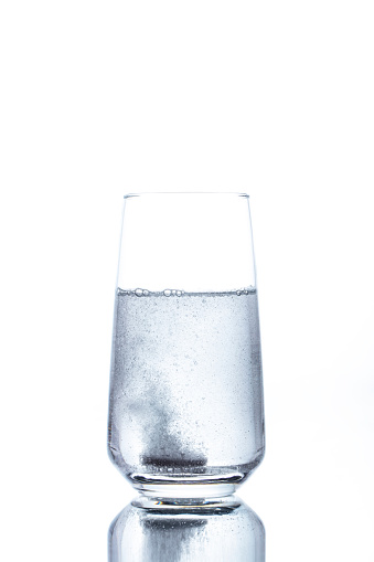 A glass of salt of soda for rinsing teeth pattern on a white background isolation