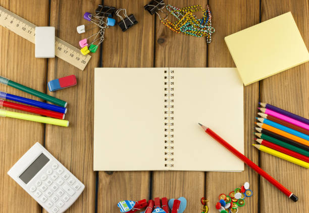 istock Blank notebook with school and office supplies on wooden 1414398398