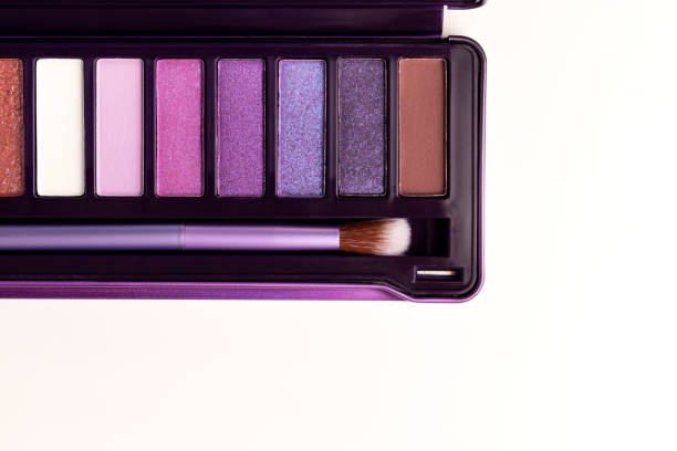 Colorful eye shadow palette on white background. Color eyeshadow palette with brush for day and evening eye makeup with matte and shimmer shadows