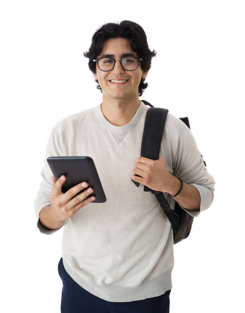Handsome male student holding tablet and looking at tablet stock photo