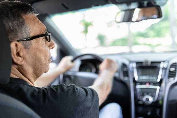 istock Senior in his 70s driving a car 1414401426