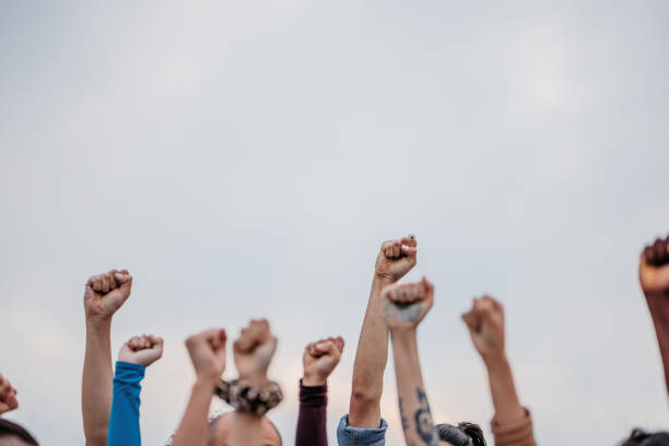 istock Protestors Raising Fists 1414401431