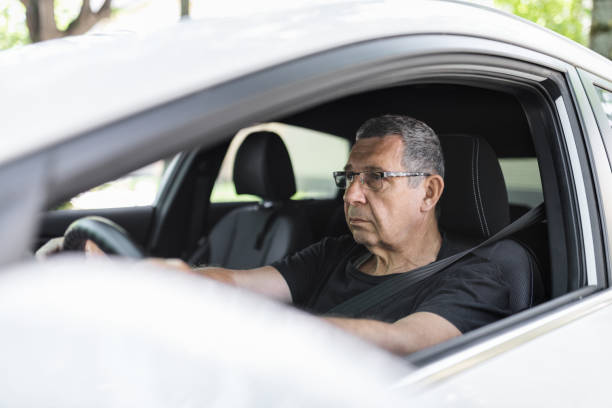 istock Senior in his 70s driving a car 1414401447