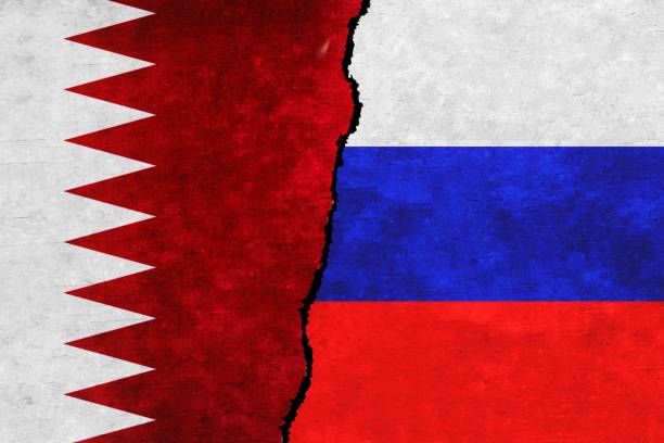 istock Russia and Qatar painted flags on a wall with a crack. 1414402054
