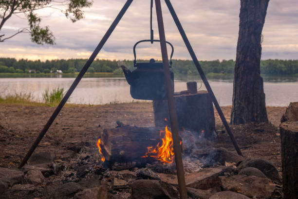 istock Kettle in the smoke of a campfire on a hike 1414402283