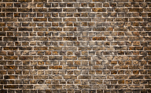 Stone wall background, brown bricks industrial texture