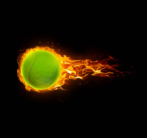 istock Tennis ball, on fire on black background 1414404885