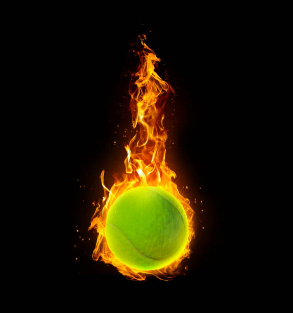 istock Tennis ball, on fire on black background 1414404901