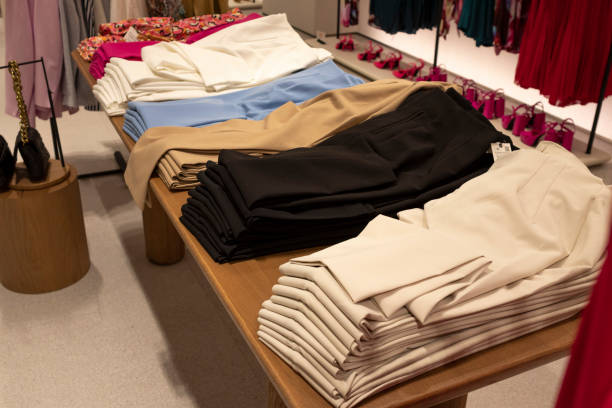 istock Women's dress pants, stacked in different colors, on a table. 1414405370