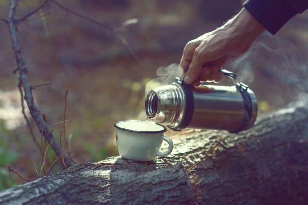istock Thermos with hot tea and a metal mug. 1414406052