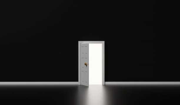 istock white door opened with light shining into dark room. 1414406259