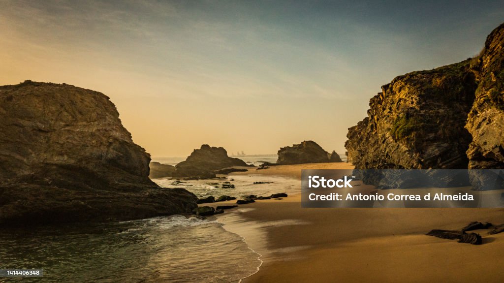 Beach in the Alentejo of Portugal, on the Vincentian coast in Porto Covo Image of an empty beach amidst rocks and sand at the end of a day Aerial View Stock Photo