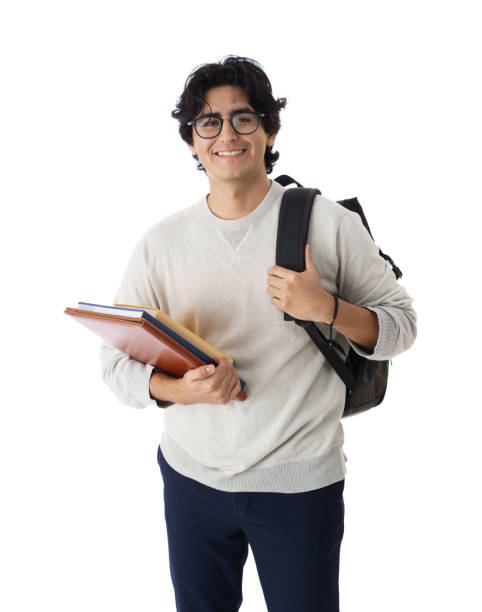 istock Male student holding backpack and books and smiling at camera 1414407893