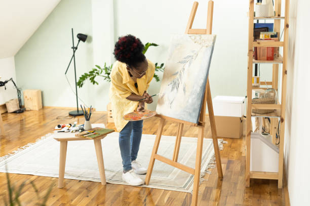 istock African female painter working on a painting at home 1414409331