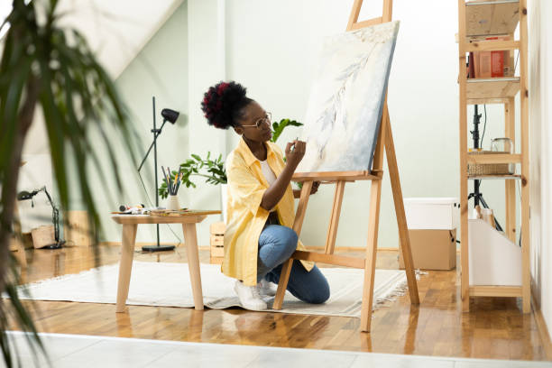 istock African female painter painting at home 1414409349