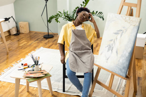 istock African female painter feeling burned out after painting 1414409360
