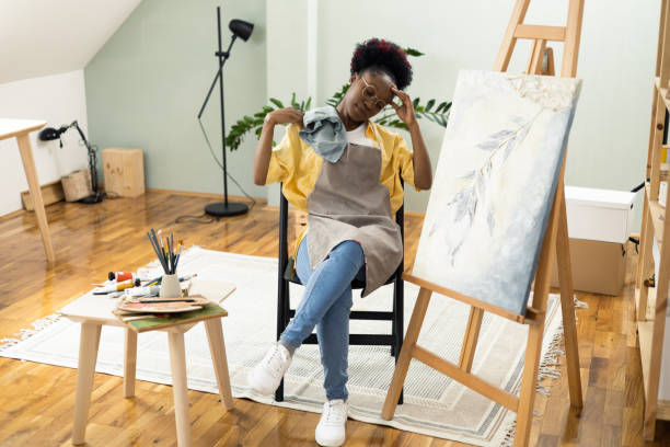istock African female painter feeling exhausted after painting 1414409371
