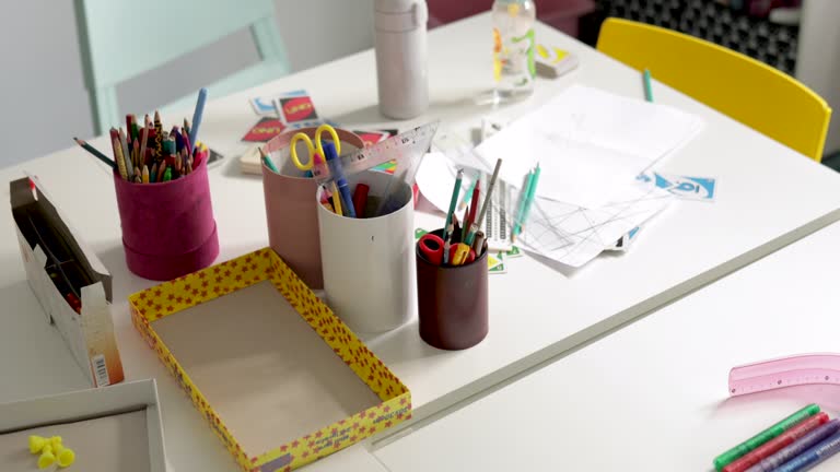 Organized school stationery on the desk in classroom