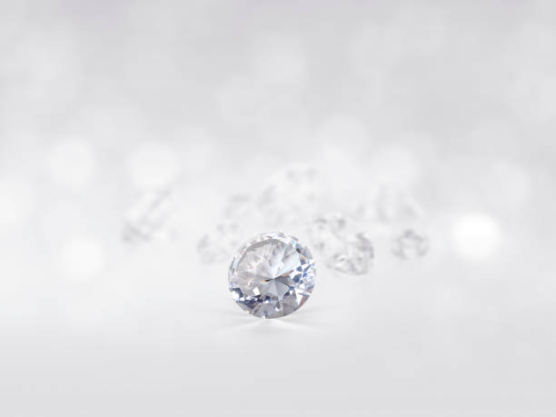 istock still with expensive cut diamonds in front of a white background, reflections on the ground. Lot of copyspace 1414411635
