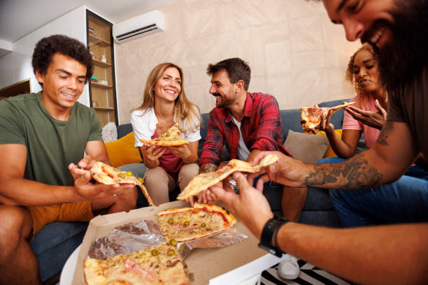 istock People eating pizza while spending leisure time at home 1414412777
