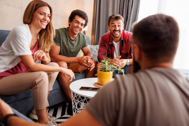 Group of friends having fun spending leisure time together at home