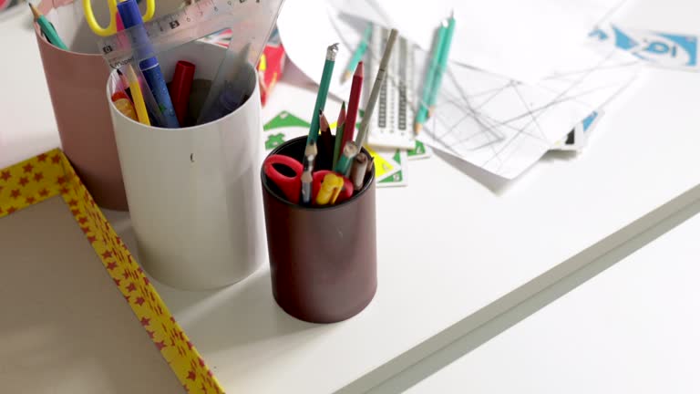 Organized school stationery on the desk in classroom