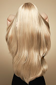 istock Back view of woman with long beautiful blond hair 1414417436