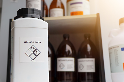 Caustic soda in bottle, chemical in the laboratory and industry