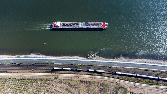 Railroad track, road, industrial ship and river - aerial view